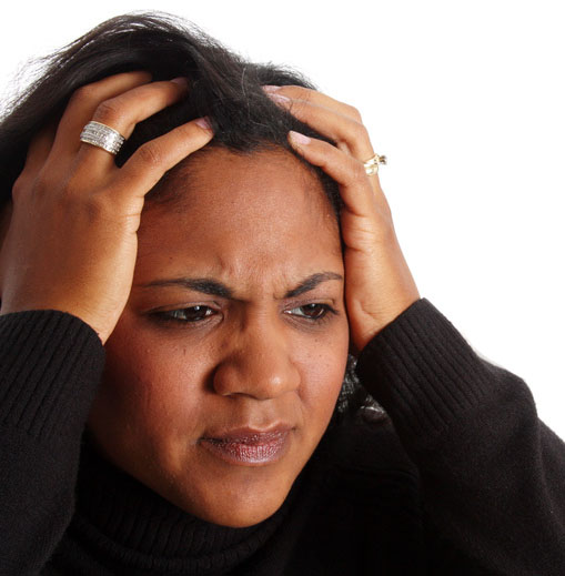Frustrated Brown skinned woman in black sweater with both hands on top of her head