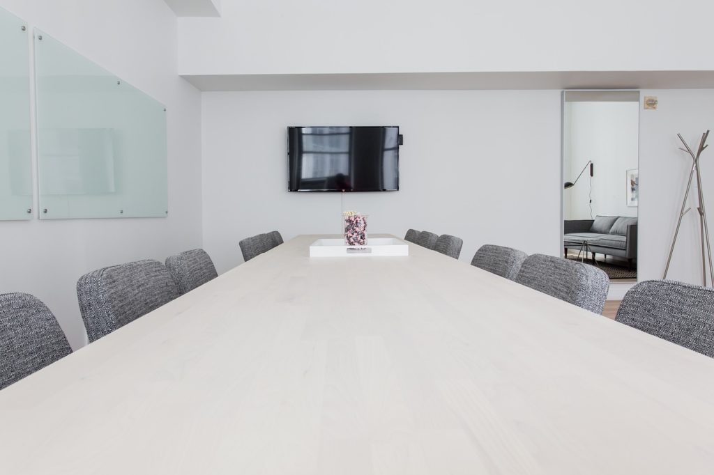 Long view of conference table lined with chairs