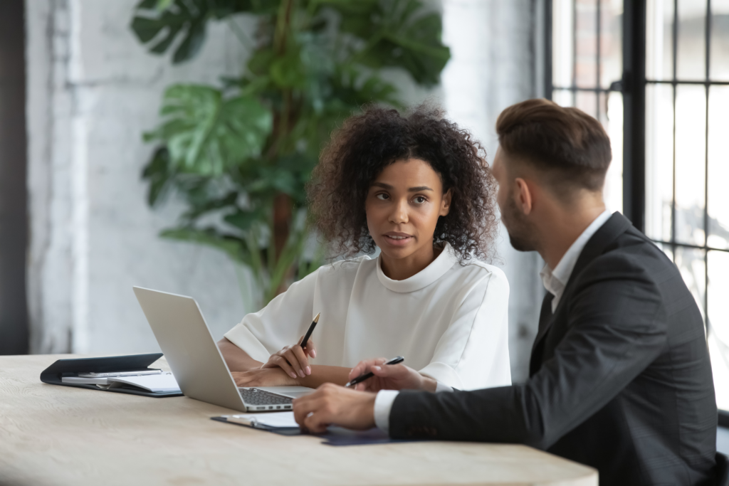Manager and employee discussing work during a one-on-one meeting